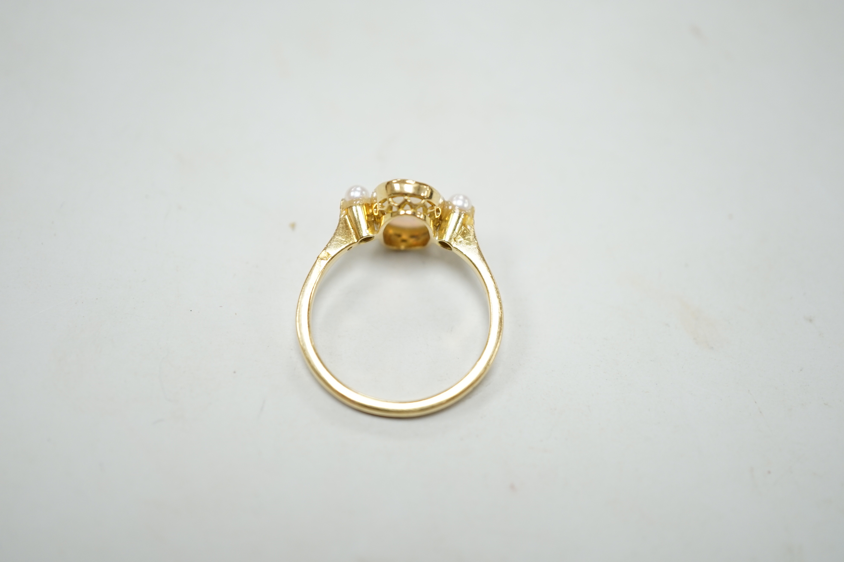 An 18ct, white opal and cultured pearl set three stone ring, size M, gross weight 3.1 grams.